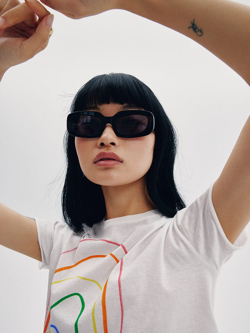 Asian model with black sunglasses and a multicolour t-shirt