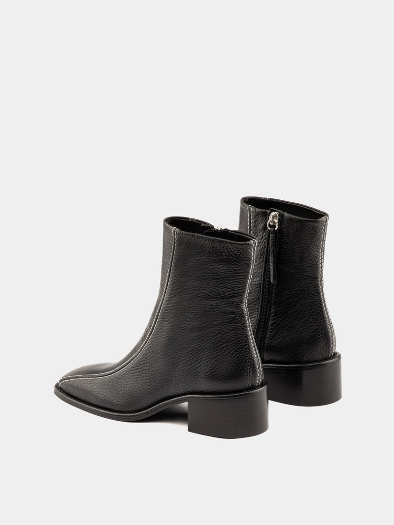 Black ankle boot with white stitching and square heel