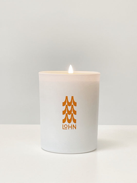 Maguire X Lohn candle on a white background