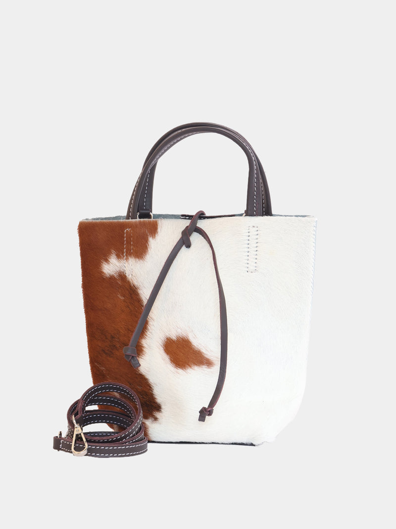 Carpi mini tote bag with cow-print pony hair and brown leather straps, showing detachable long strap.
