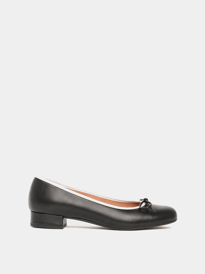 Black ballerina pump with white piping and black bow