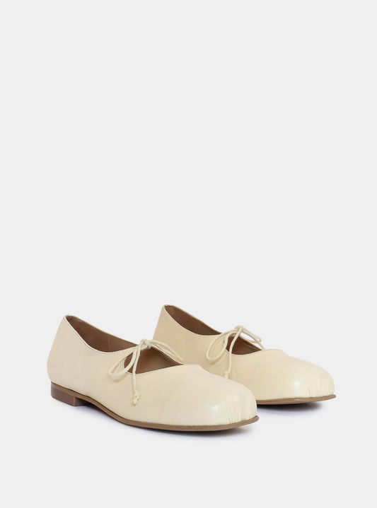 cream ballerina on gray background