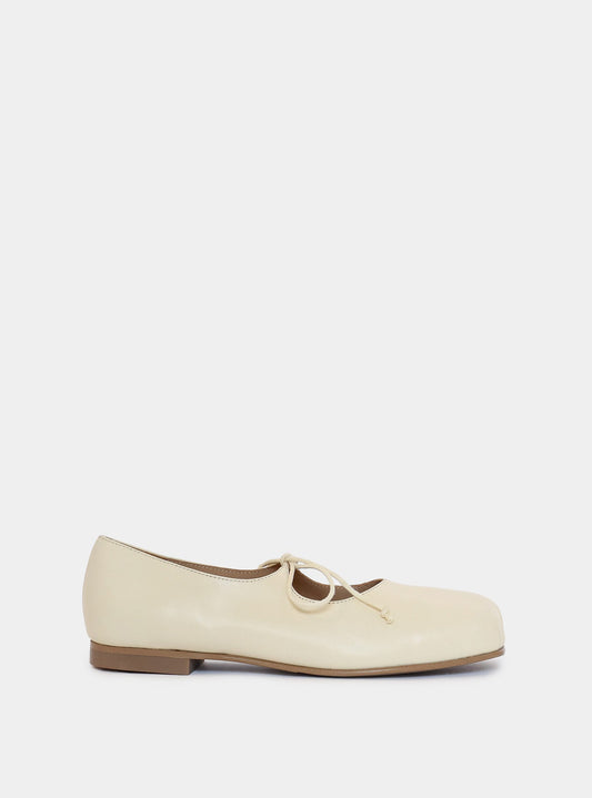 cream ballerina on gray background
