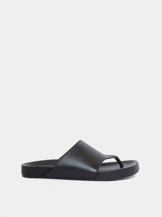black flip flop on grey background