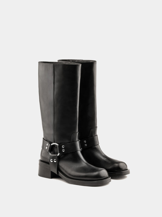 Knee-high black moto boots with a silver harness