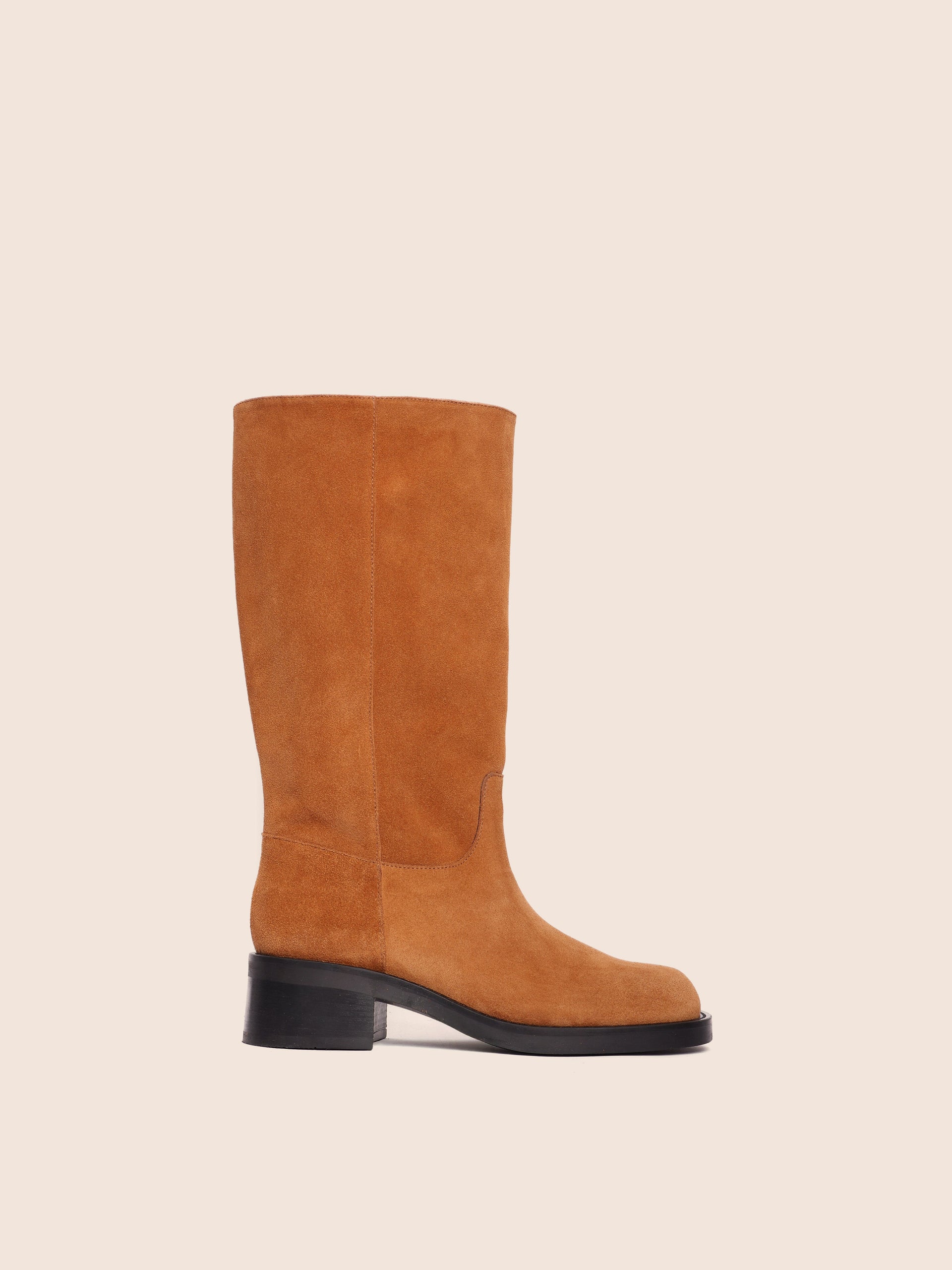A tan suede boot with harness detailing and a mid-height heel, made in Italy.