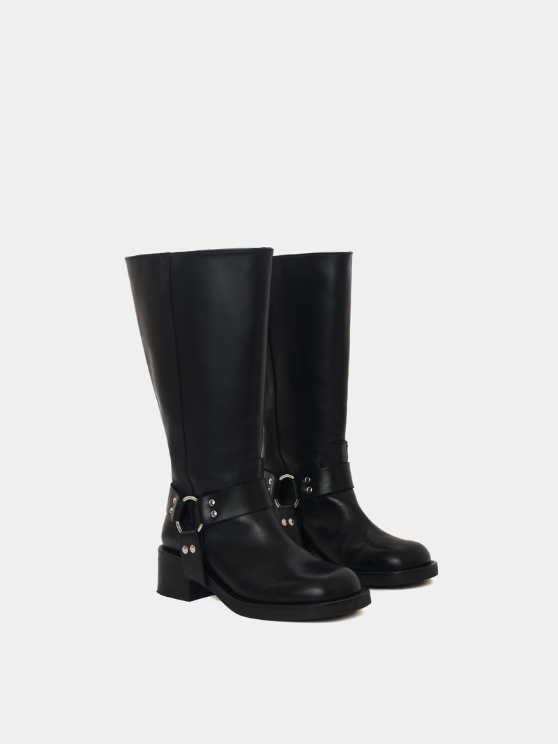 Knee-high black moto boots with a silver harness