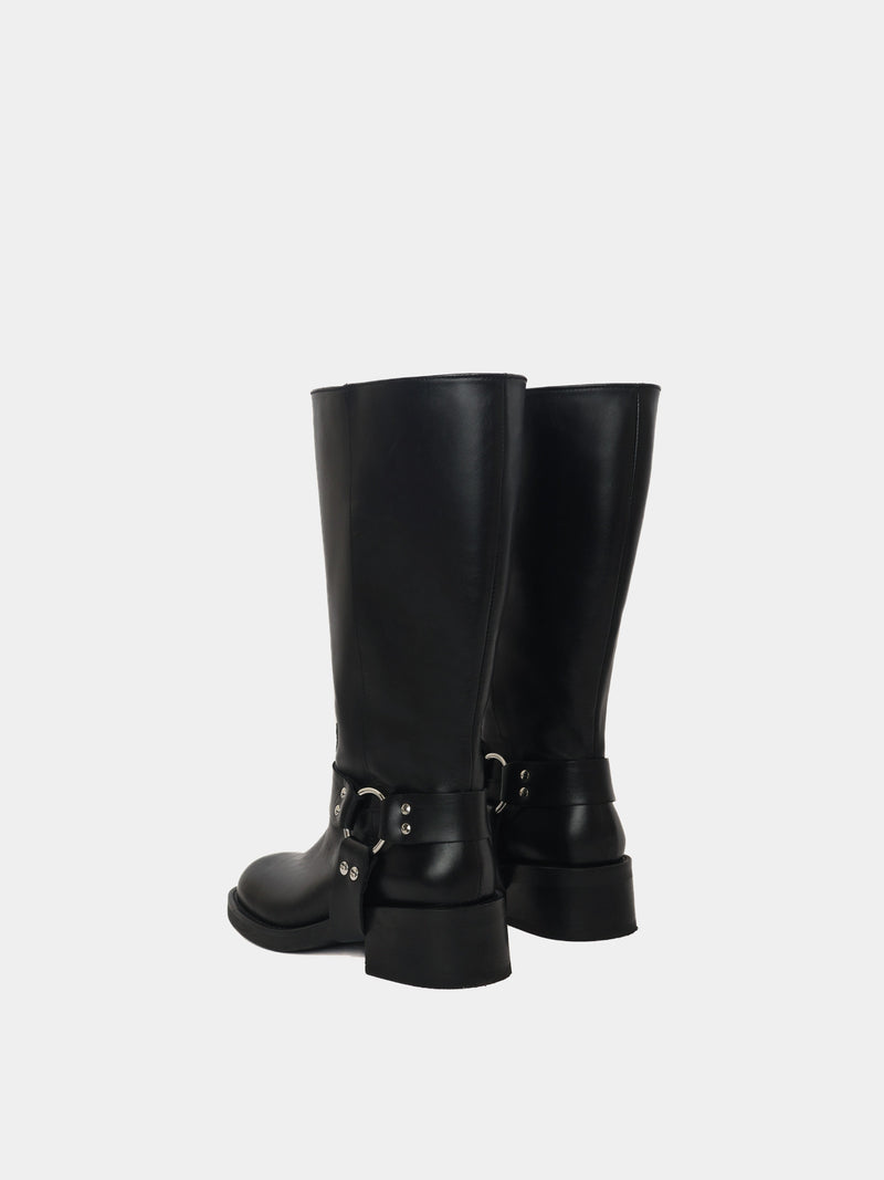 Knee-high black moto boots with a silver harness