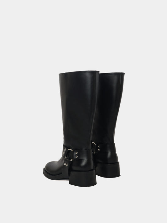Knee-high black moto boots with a silver harness