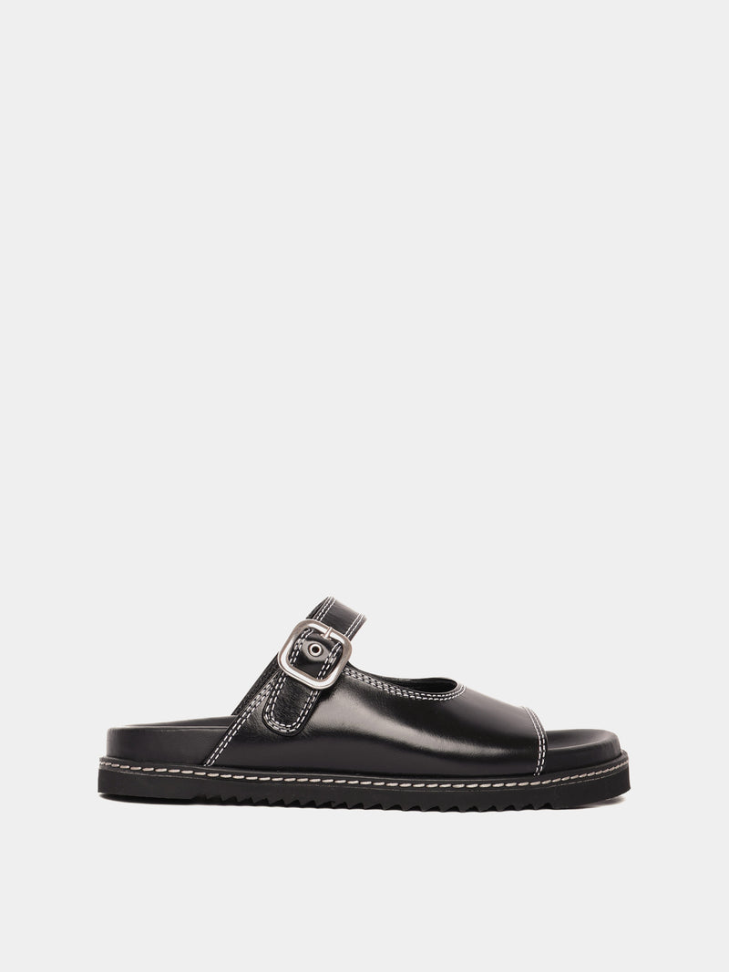 A black sandal with an adjustable buckle strap and a flat sole.