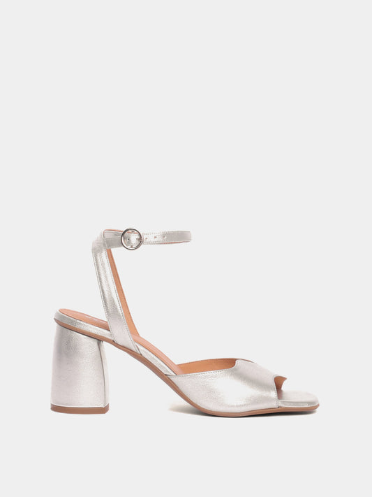 A silver metallic heel with an asymmetric wave design and an adjustable ankle strap.