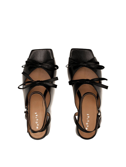 Mira black leather square-toe heel with ankle strap and two bows, top view.