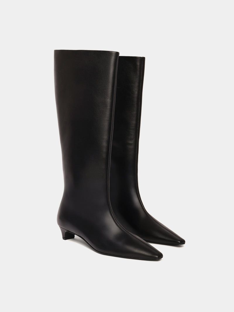 Knee-high black leather boots with a low heel and pointed toes