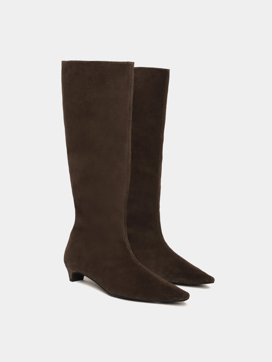 Knee-high brown suede boots with a low heel and pointed toes