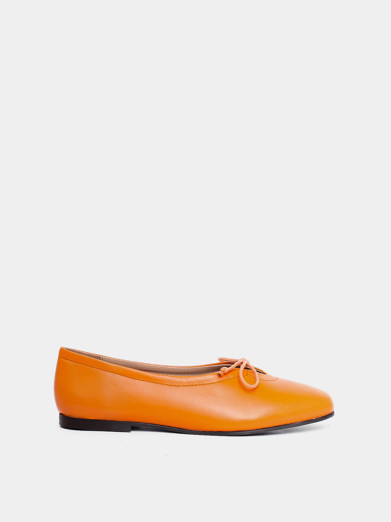 orange ballet flat on grey background