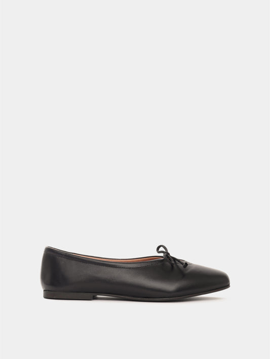 Black leather ballerina flat with a black bow