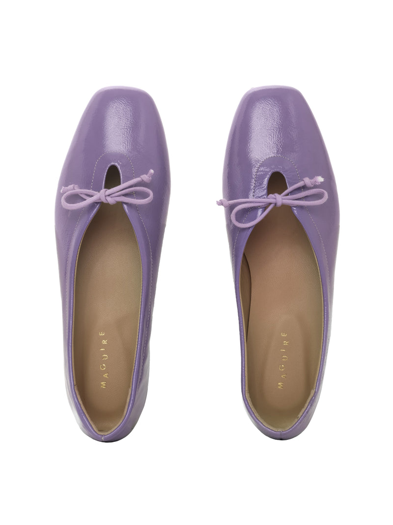 Violet patent leather ballerina flats with a lilac bow