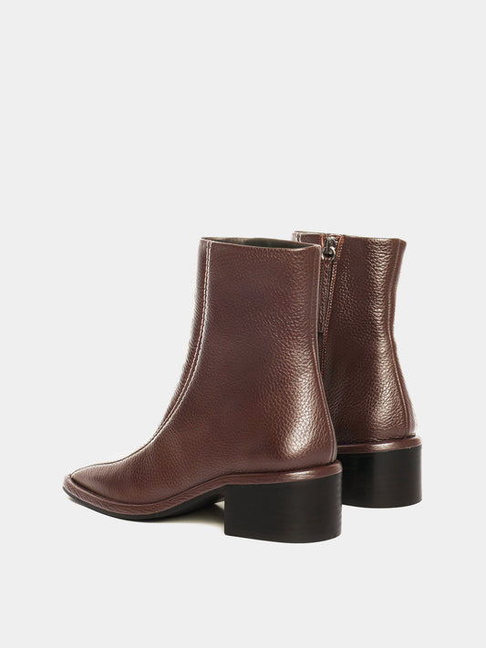 Brown leather ankle boots with white contrast stitching and a block heel