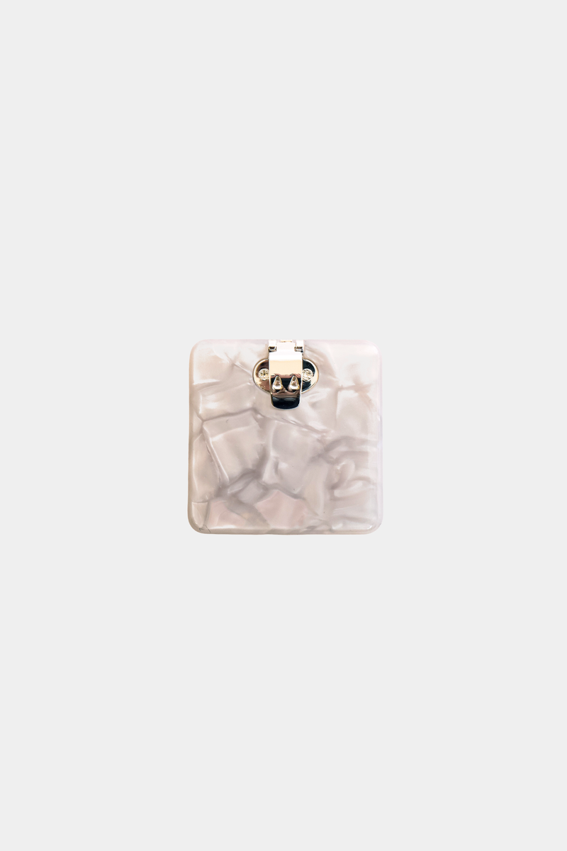 Ecom image of a square acetate shoe clip, cream coloured, back clasp.
