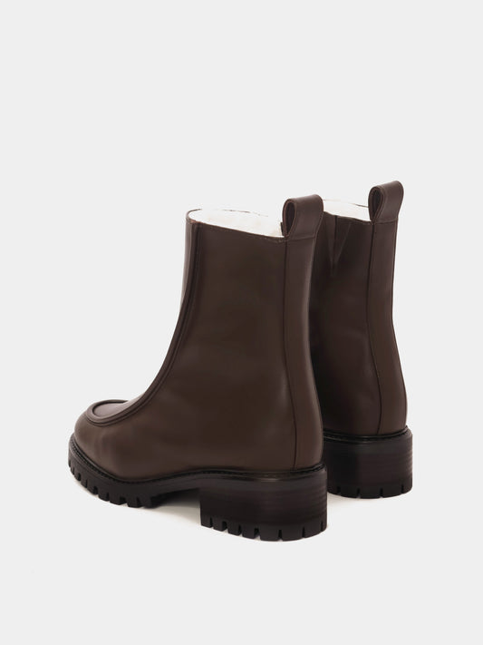 Brown leather lined winter boot with rounded toe, 3d piping detailing and a back tab.
