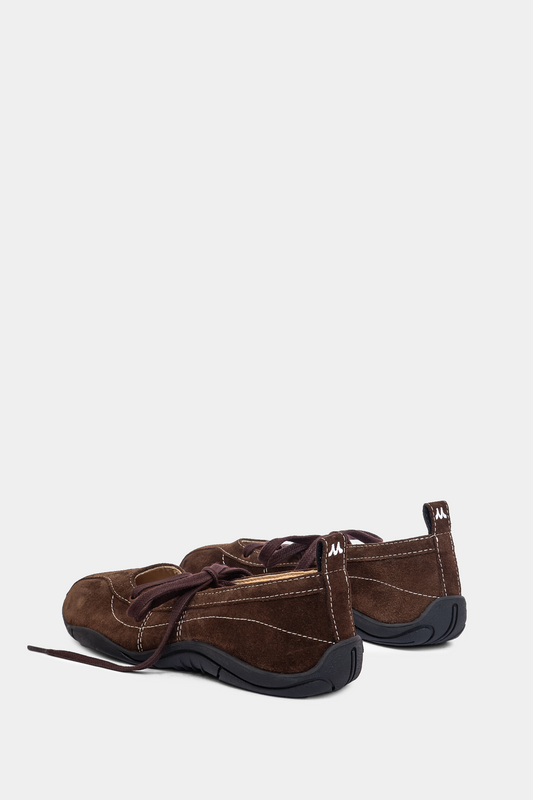 brown suede sneaker ballerina with laces, back tab & sporty black outsole on grey background