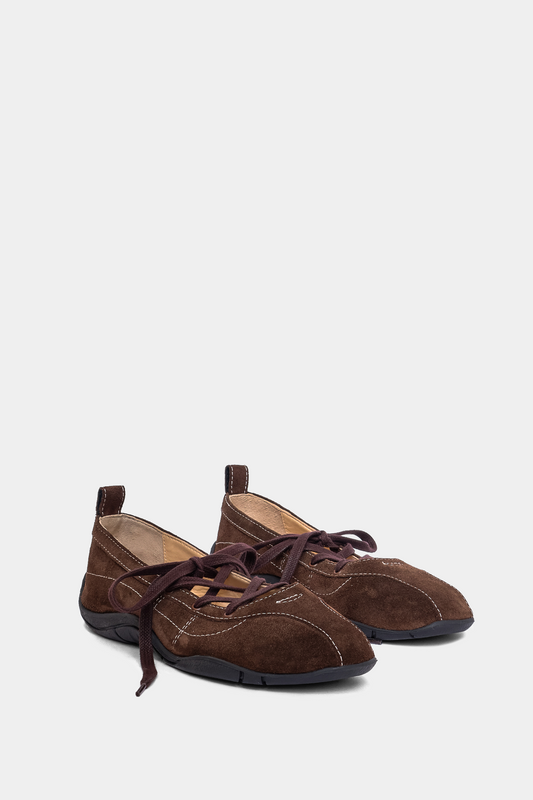 brown suede sneaker ballerina with laces, back tab & sporty black outsole on grey background
