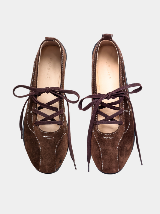 Pair of brown suede shoes with laces on a light gray background