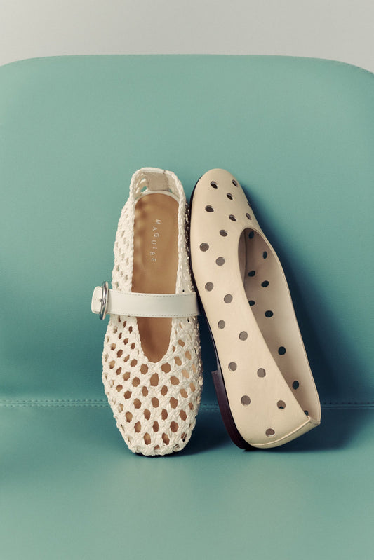 mint green chair with two pairs of cut-out ballet flats in cream