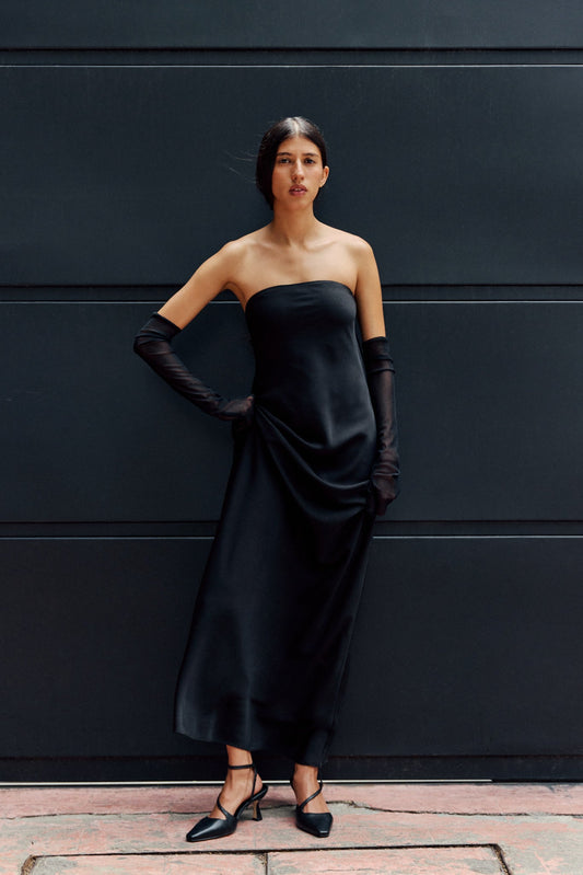Woman in black dress wearing black heels