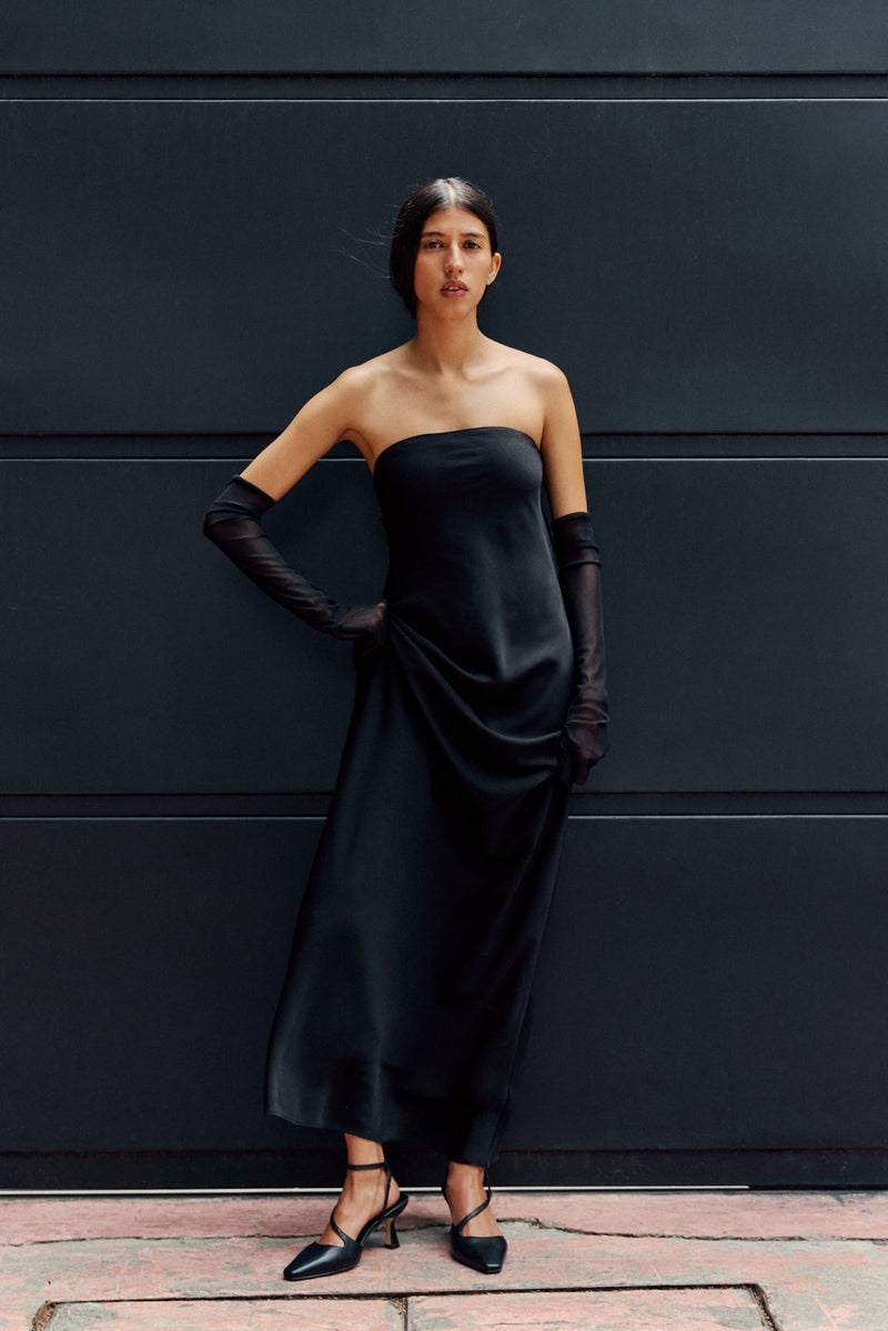 Woman in black dress wearing black heels