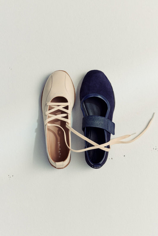 two ballet flats laying next to each other on white background