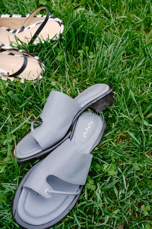 Gray sandals on grass