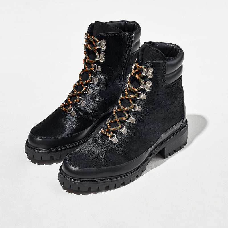 Green and orange laces on black pony hair boots