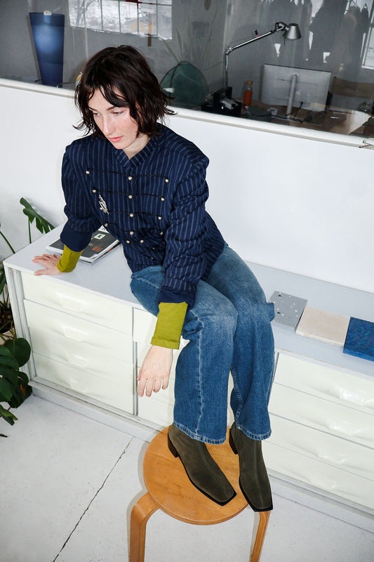 Person sitting on a stool in a kitchen with Palma Boots
