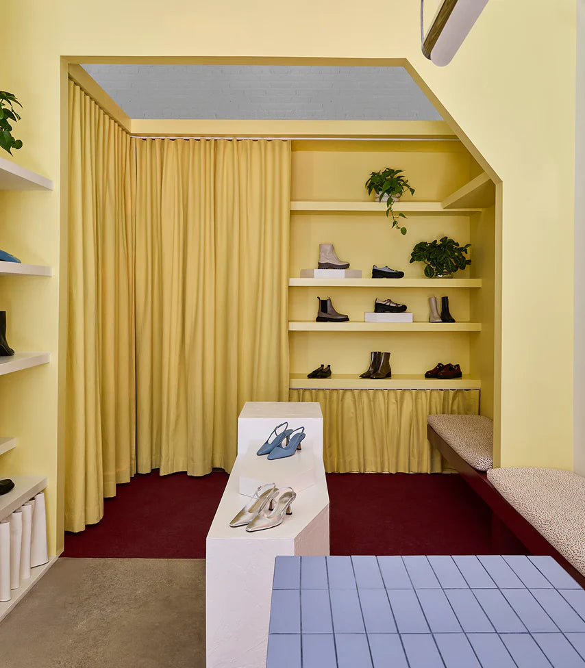 Our Brooklyn store features a unique design. This corner of the store is painted all yellow and showcases our signature wardrobe.