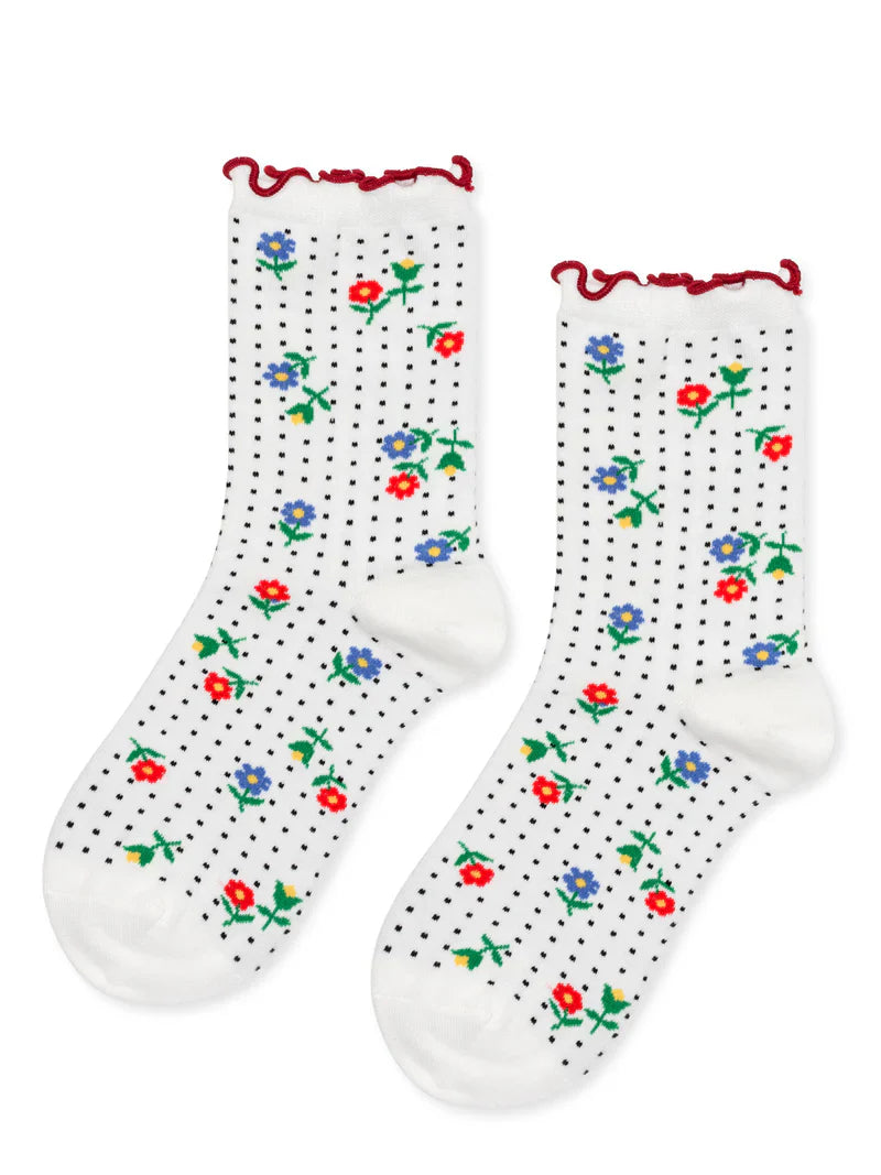 White socks with floral patterns and red trim on a white background