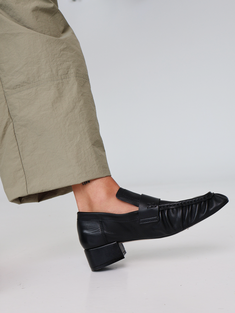 Black leather loafers with a small heel